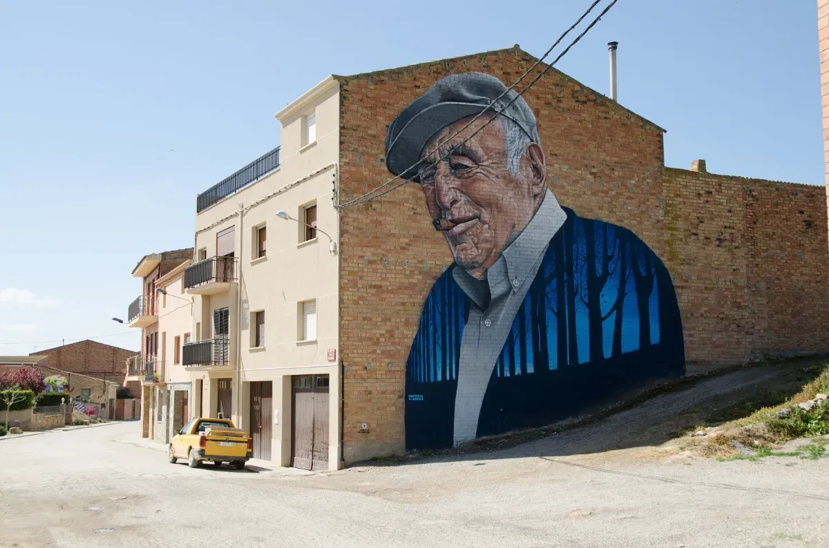 In Penelles, a rural Catalan town absolutely worth visiting, every mural carries the hand of its creator and the story of a village that chose color and meaning over empty walls—proof of humanity you can walk through.