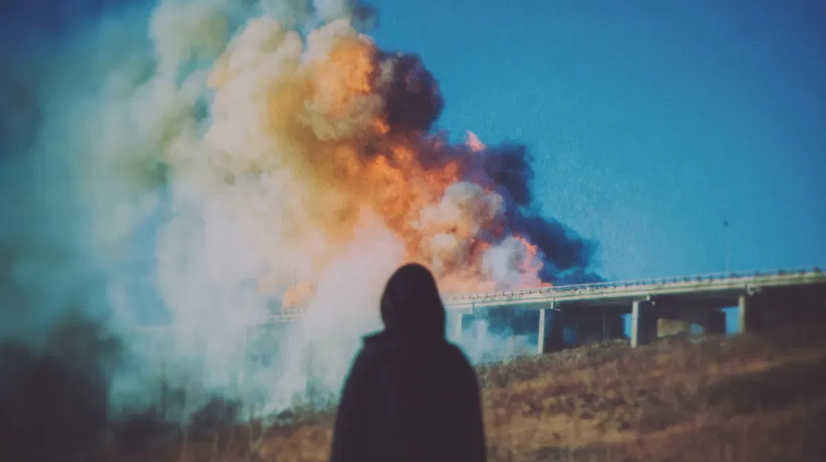 But burn, burn, burn... A person watching a bridge burn